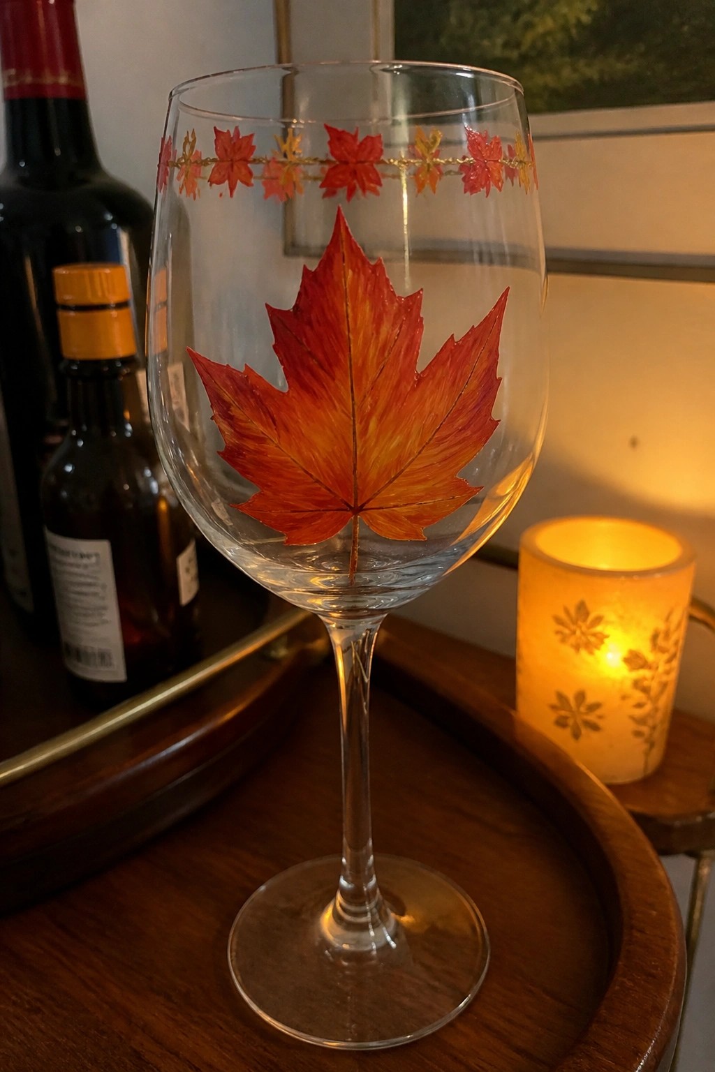 Wine glass with large red maple leaf painting and gold autumn leaf rim border