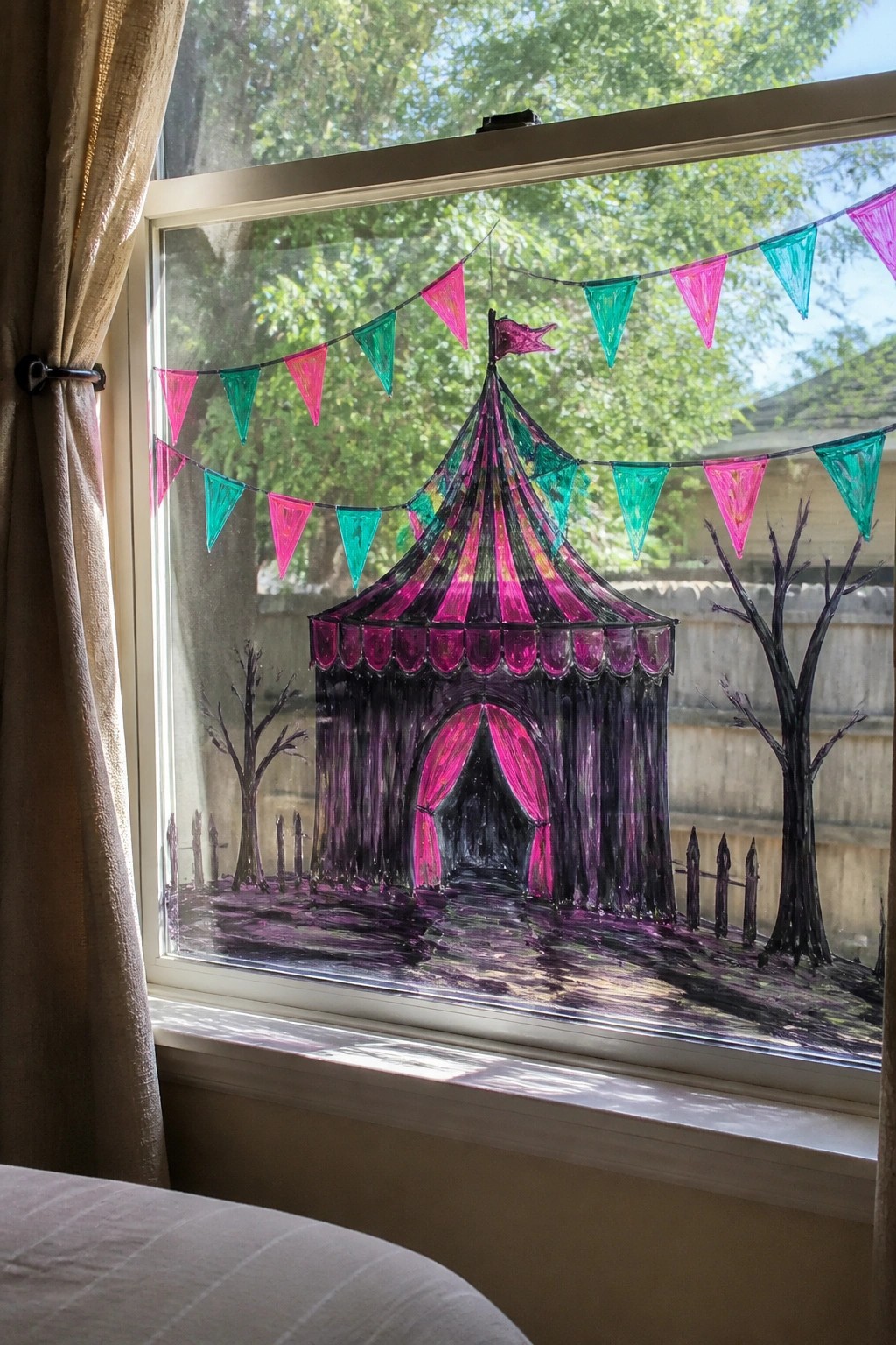 Colorful circus tent drawing with pink-green bunting on window glass