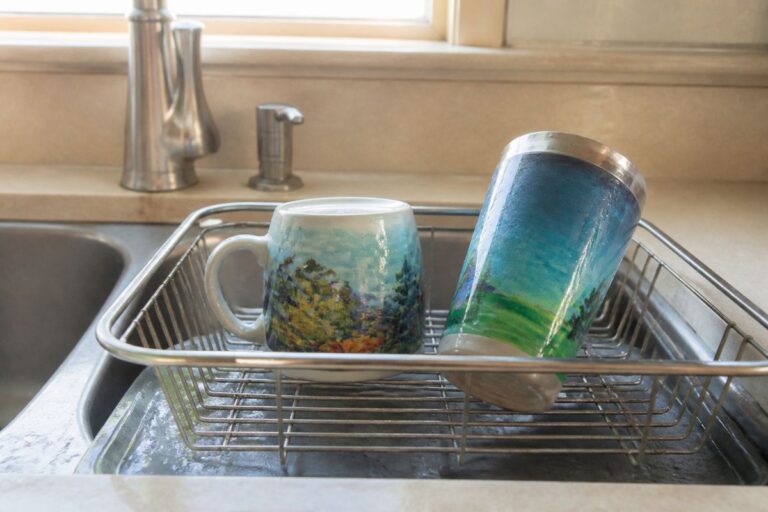 Painted drinkware next to a kitchen sink