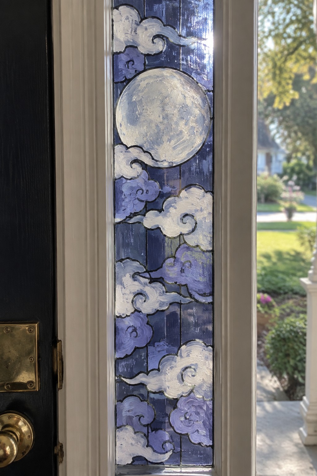 Stained glass door panel with moon and swirling blue-white clouds