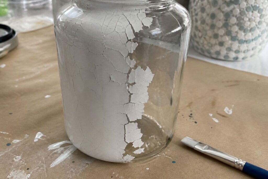 Paint peeling from a glass jar where prep was skipped